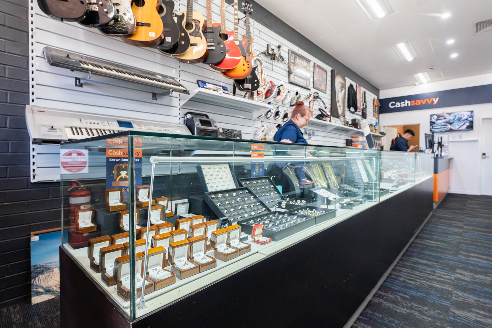 Cash Savvy store interior with jewellery in glass display and staff behind the counter.